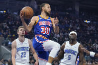 Golden State Warriors guard Stephen Curry (30) passes the ball in front of Orlando Magic forward Franz Wagner (22) and center Mo Bamba (5) during the first half of an NBA basketball game in San Francisco, Monday, Dec. 6, 2021. (AP Photo/Jeff Chiu)