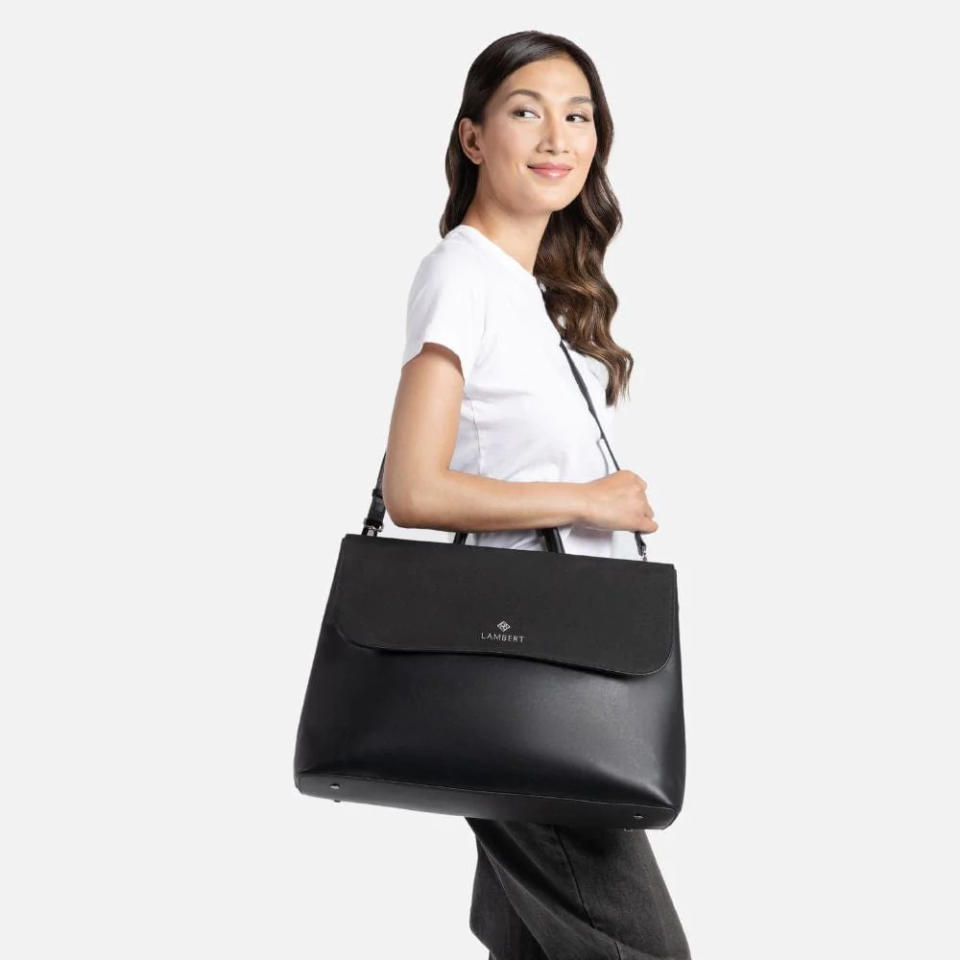 Model holding the Helena - 2-In-1 Black Vegan Leather Handbag