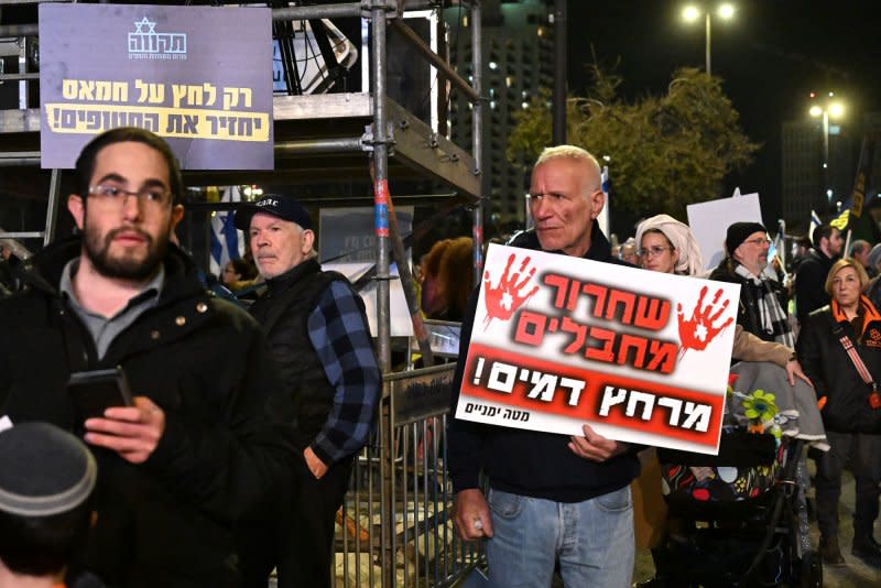 An Israeli man holds a placard warning that the "Release of terrorists will bring blood shed" during a protest outside the office of Prime Minister Benjamin Netanyahu in Jerusalem on Thursday. Photo by Debbie Hill/UPI