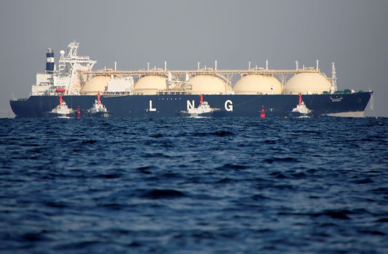 FILE PHOTO: An LNG tanker is tugged towards a thermal power station in Futtsu