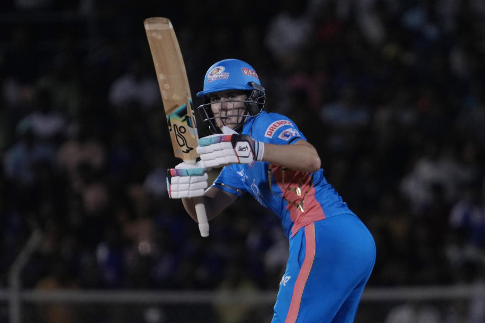 Mumbai Indians Natalie Sciver watches the ball after playing a shot during the Women's Premier League Twenty20 cricket final match between Delhi Captials and Mumbai Indians in Mumbai, India, Sunday, March 26, 2023. (AP Photo/Rajanish Kakade)