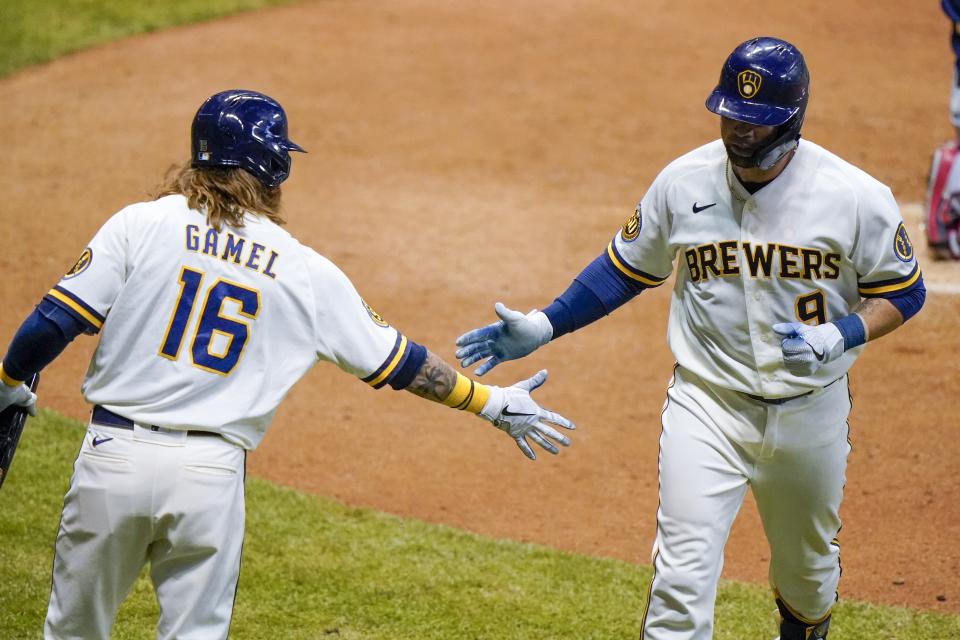 Milwaukee Brewers' Manny Pina is congratulated by Ben Gamel after hitting a home run during the fifth inning of a baseball game against the Minnesota Twins Tuesday, Aug. 11, 2020, in Milwaukee. (AP Photo/Morry Gash)