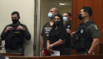 Former UFC heavyweight champion Cain Velasquez, second from left, with his attorney Alexandra Kazarian, makes an initial court appearance at the Santa Clara County Hall of Justice on Wednesday, March 2, 2022, in San Jose, Calif. Velasquez was arrested Monday on suspicion of attempted murder after he allegedly shot a man in Northern California, police said. (Aric Crabb/Bay Area News Group via AP, Pool)