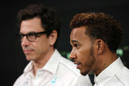 FILE PHOTO: Formula One World Champion, Mercedes' Lewis Hamilton speaks next to Mercedes Executive Director Toto Wolff ahead of the United States Grand Prix during an interview with Reuters at the Nasdaq Market Site in New York City, New York, U.S., October 17, 2018. REUTERS/Mike Segar/File Photo