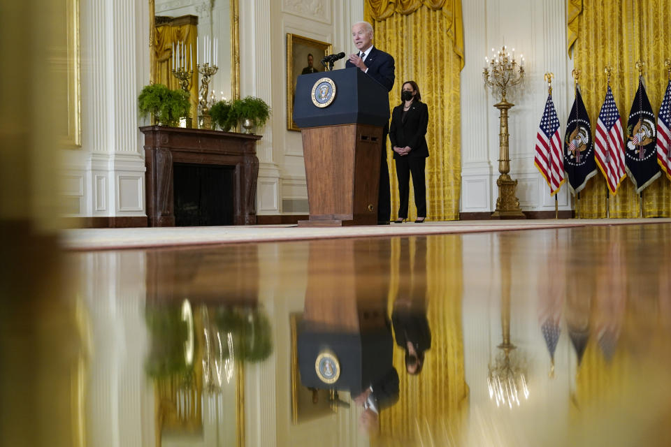 FILE - President Joe Biden speaks about his domestic agenda from the East Room of the White House in Washington, Oct. 28, 2021, as Vice President Kamala Harris looks on. Harris is capping off a controversial first year in office, creating history as the first woman of color in her position while fending off criticism and complaints over her focus and agenda. While she’s sought to make the office her own, Harris has struggled at times with the constraints of a global pandemic and the realities of a role focused squarely on promoting the president. (AP Photo/Susan Walsh, File)