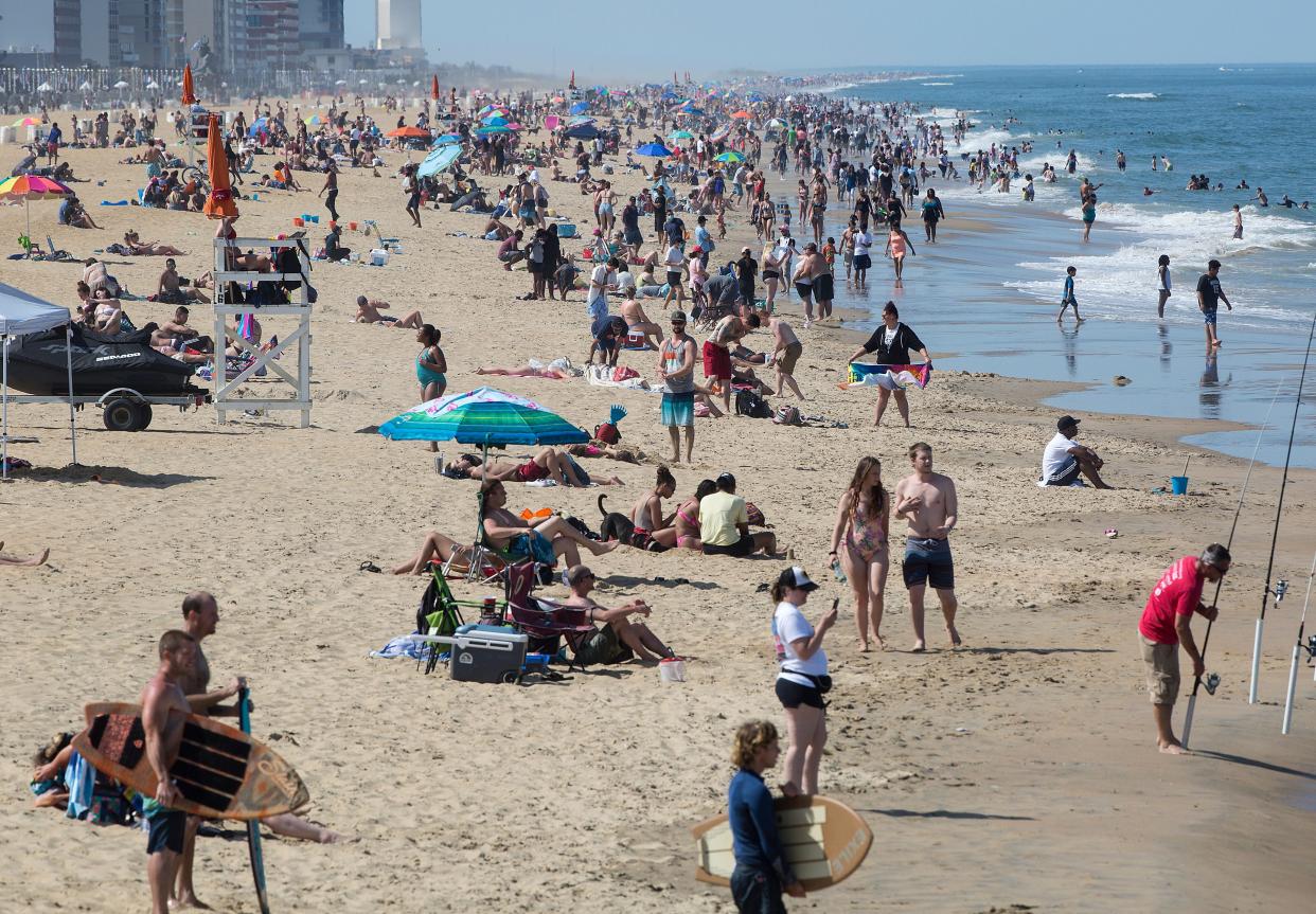 In this 2020 photo, warm weather draws crowds to the oceanfront in Virginia Beach.