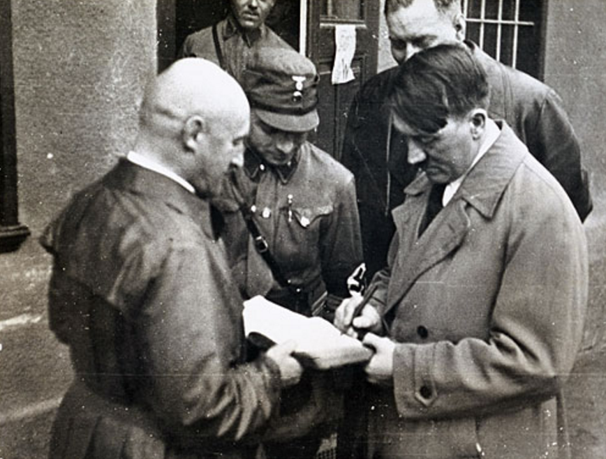 hitler signs a book