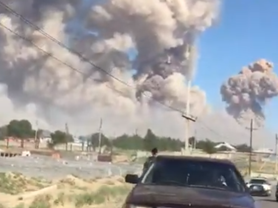 A town of 44,000 people has been evacuated in Kazakhstan after a series of huge explosions at a nearby weapons depot killed at least one person and injured dozens more, authorities said. The blasts occurred on Monday at a military base near Arys in the Central Asian country's southern Turkestan province, which features a large Soviet-era storage facility for explosive munitions. A video posted online shows locals running from the scene as massive clouds of smoke and dust rise into the sky behind them, accompanied by the sound of thunder-like booms. Another video shows agitated soldiers screaming profanities as they run out of the military base in full gear, stepping on shattered glass.They can be seen stopping two cars on a nearby highway and ordering the drivers to take away several civilian women they had escorted out of the facility. The soldiers drop to the ground as more explosions are heard.The cause of the fire which led to the explosions was unclear. Similar incidents in the area, in 2009, 2014 and 2015, were blamed on negligence and failure to observe safety regulations.Provincial governor Umirzak Shukeyev told a briefing one person had been killed and 31 injured. The authorities warned locals against trying to return to the town because unexploded shells could turn its streets into minefields."The scale (of fires) is very large and this could go on for a few days," Mr Shukeyev said.Kazakh president Kassym-Jomart Tokayev wrote on Twitter he had ordered the government to ensure the safety of the local population and investigate the cause of the blasts.Mr Tokayev is heading to Arys himself, along with senior officials, his spokesman said.Additional reporting by Reuters