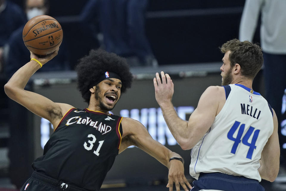 Cleveland Cavaliers' Jarrett Allen (31) tries to pass the ball against Dallas Mavericks' Nicolo Melli (44) in the first half of an NBA basketball game, Sunday, May 9, 2021, in Cleveland. (AP Photo/Tony Dejak)