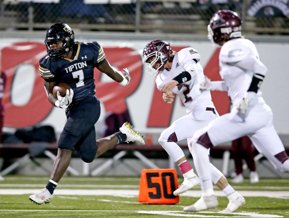 Tipton's Prince Dweh gets by Waynoka's Teegun Alllison on the way to a touchdown during the Class C football state championship game last season in Bethany.