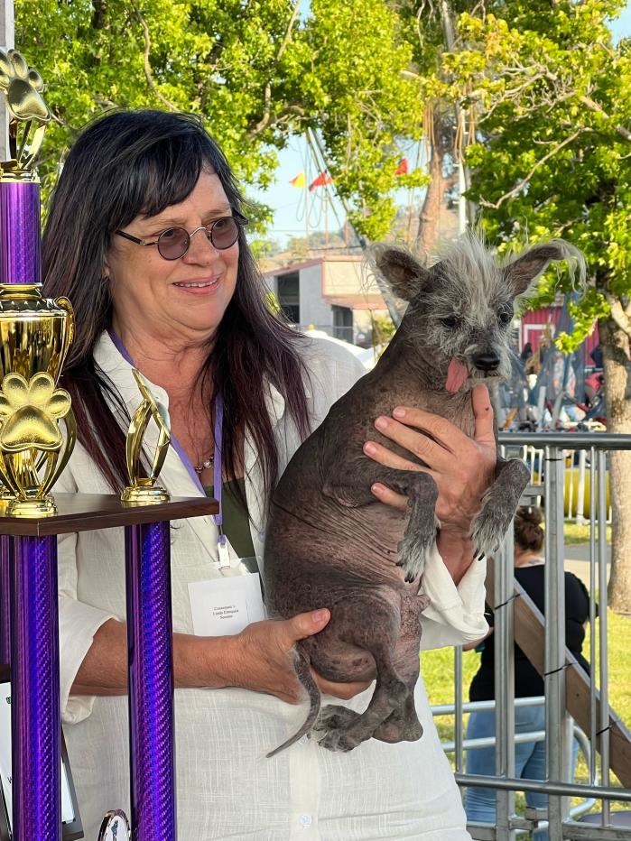 Linda Celeste Elmquist and Scooter with their award. (Sumiko Moots)