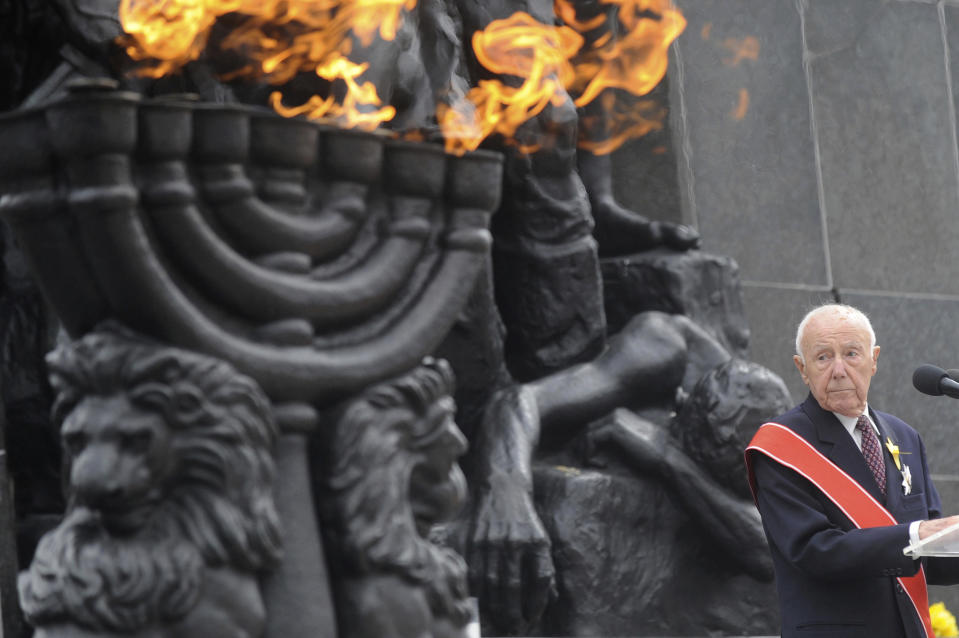 FILE - In this Friday, April 19, 2013, file photo, Simcha Rotem, the last known remaining Jewish fighter from the 1943 Warsaw ghetto uprising against the Nazis, speaks in front of the Warsaw Ghetto Uprising memorial during the revolt anniversary ceremonies in Warsaw, Poland. Rotem has died on Sunday, Dec. 23, 2018. He was 94. (AP Photo/Alik Keplicz, File)