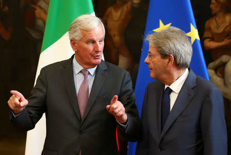 European Union's chief Brexit negotiator Michel Barnier (L) speaks with Italy's Prime Minister Paolo Gentiloni during a meeting in Rome, Italy September 21, 2017. REUTERS/Alessandro Bianchi