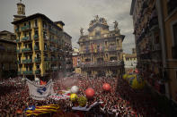 <p>People celebrate during the launch of the <em>chupinazo</em> rocket to celebrate the official opening of the 2017 San Fermín Fiesta. (Photo: Alvaro Barrientos/AP) </p>