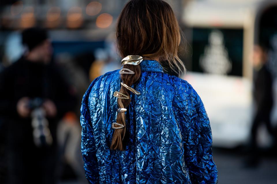 Wear all the clips you impulse-bought at once by slipping them into a loose, low braid.