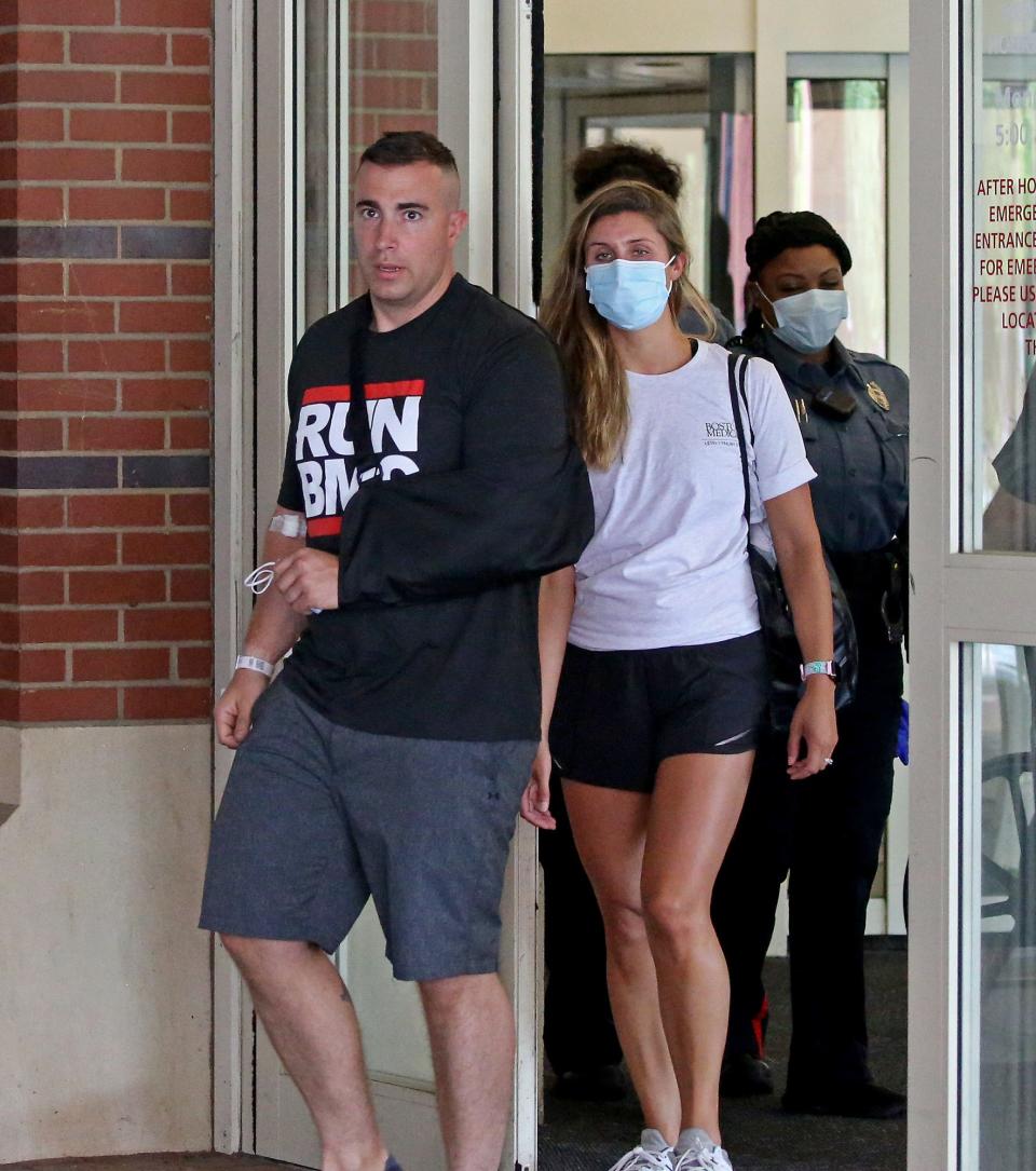 Braintree police officer Matthew Donoghue leaves Boston Medical Center with his wife on June 5, 2021.