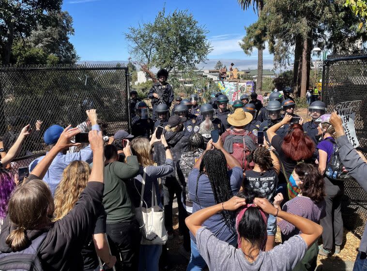 BERKELEY CA AUGUST 3, 2022 - Protesters confront officers as they try to break through fence into People's Park in Berkeley, Wednesday August 3, 2022. The park has been fenced off and closed as UC Berkeley will build student housing on the site. (Stuart Leavenworth / Los Angeles Times)