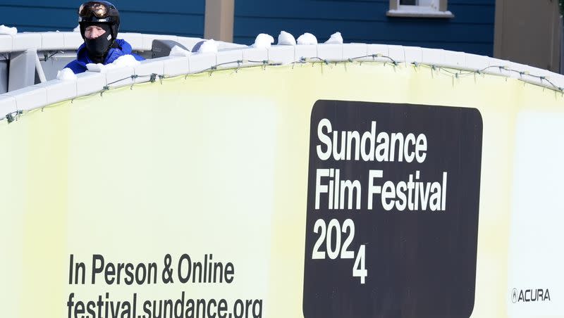 A skier walks past an advertisement for the 2024 Sundance Film Festival on the opening day of the festival, Thursday, Jan. 18, 2024, in Park City, Utah. 