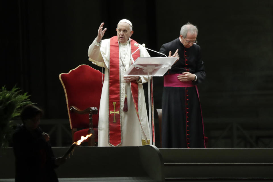Pope Francis is flanked by Mons. Guido Marini as he delivers his blessing during the Via Crucis – or Way of the Cross – ceremony in front of St. Peter's Basilica, empty of the faithful following Italy's ban on gatherings during a national lockdown to contain contagion, at the Vatican, Friday, April 10, 2020. (AP Photo/Andrew Medichini, Pool)