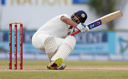 Cricket - Sri Lanka v India - First Test Match - Galle, Sri Lanka - July 27, 2017 - India's cricketer Ajinkya Rahane falls after avoiding a bouncer ball by Sri Lanka's Nuwan Pradeep. REUTERS/Dinuka Liyanawatte