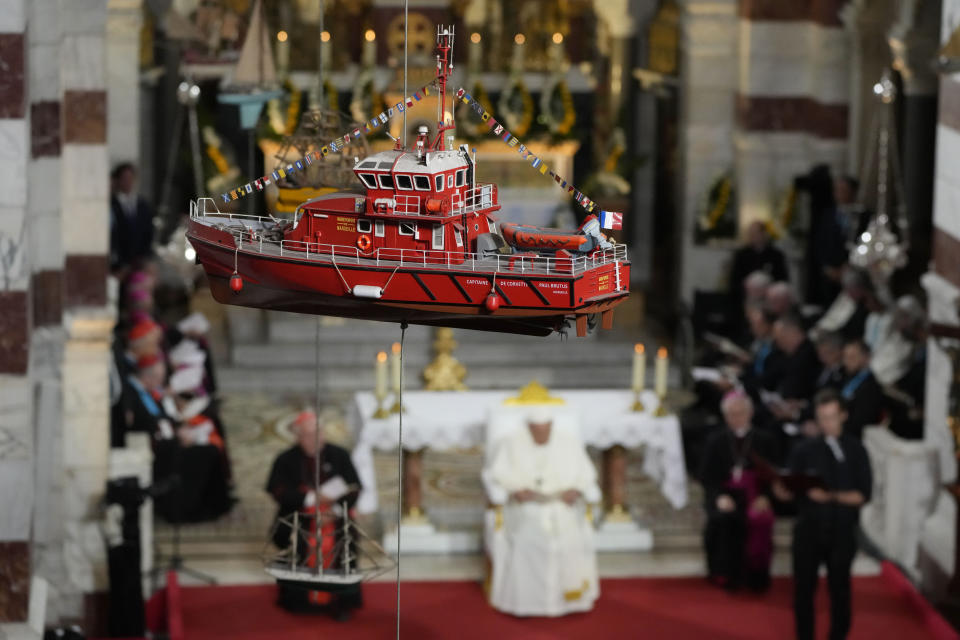 A model boat hanging from the ceiling of the Notre Dame de la Garde Basilica is seen as Pope Francis delivers his speech during a Marian prayer with the diocesan clergy, in Marseille, France, Friday, Sept. 22, 2023. Francis, during a two-day visit, will join Catholic bishops from the Mediterranean region on discussions that will largely focus on migration. (AP Photo/Alessandra Tarantino)
