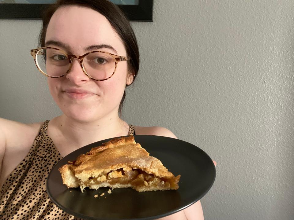 Paige Bennet holding up Alton Brown's pie.