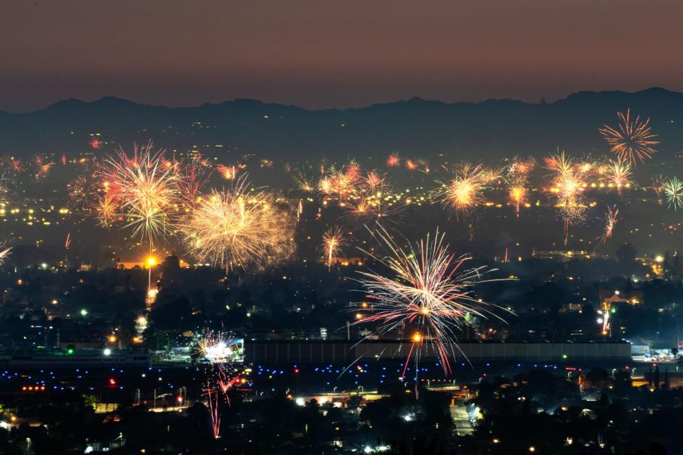 Fireworks light up the sky over North Hollywood, as seen from Burbank.