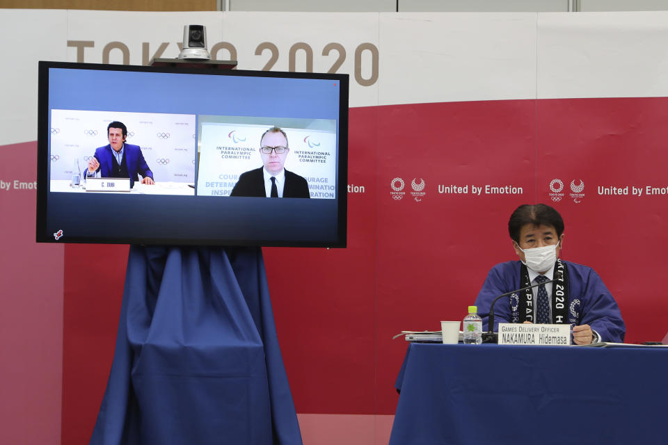 Hidemasa Nakamura, right, games delivery officer for the Tokyo Organizing Committee of the Olympic and Paralympic Games (Tokyo 2020), joins other representatives from the International Olympic Committee (IOC) and the International Paralympic Committee (IPC) at a Joint press briefing in Tokyo on Wednesday, Feb. 3, 2021. Tokyo 2020, IOC and IPC announced Wednesday they jointly developed and published the first version of "The Playbooks," which contains advice from international and Japanese health experts for COVID-19 countermeasures as well as the guidelines and rules that each games stakeholder will need to observe in order to play their part in ensuing a safe and secure games. (Du Xiaoyi/Pool Photo via AP)