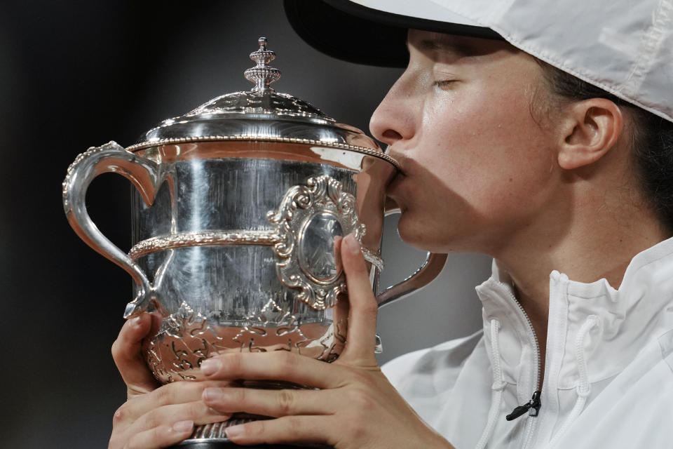 Poland's Iga Swiatek kisses the trophy after winning the final against Coco Gauff of the U.S. in two sets, 6-1, 6-3, at the French Open tennis tournament in Roland Garros stadium in Paris, France, Saturday, June 4, 2022. (AP Photo/Thibault Camus)