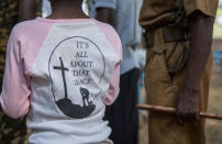 <p>A former female child soldier (L) stands next to her former army commander during the release ceremony in Yambio, South Sudan on Feb. 7, 2018. (Photo: Stefanie Glinski/AFP/Getty Images) </p>