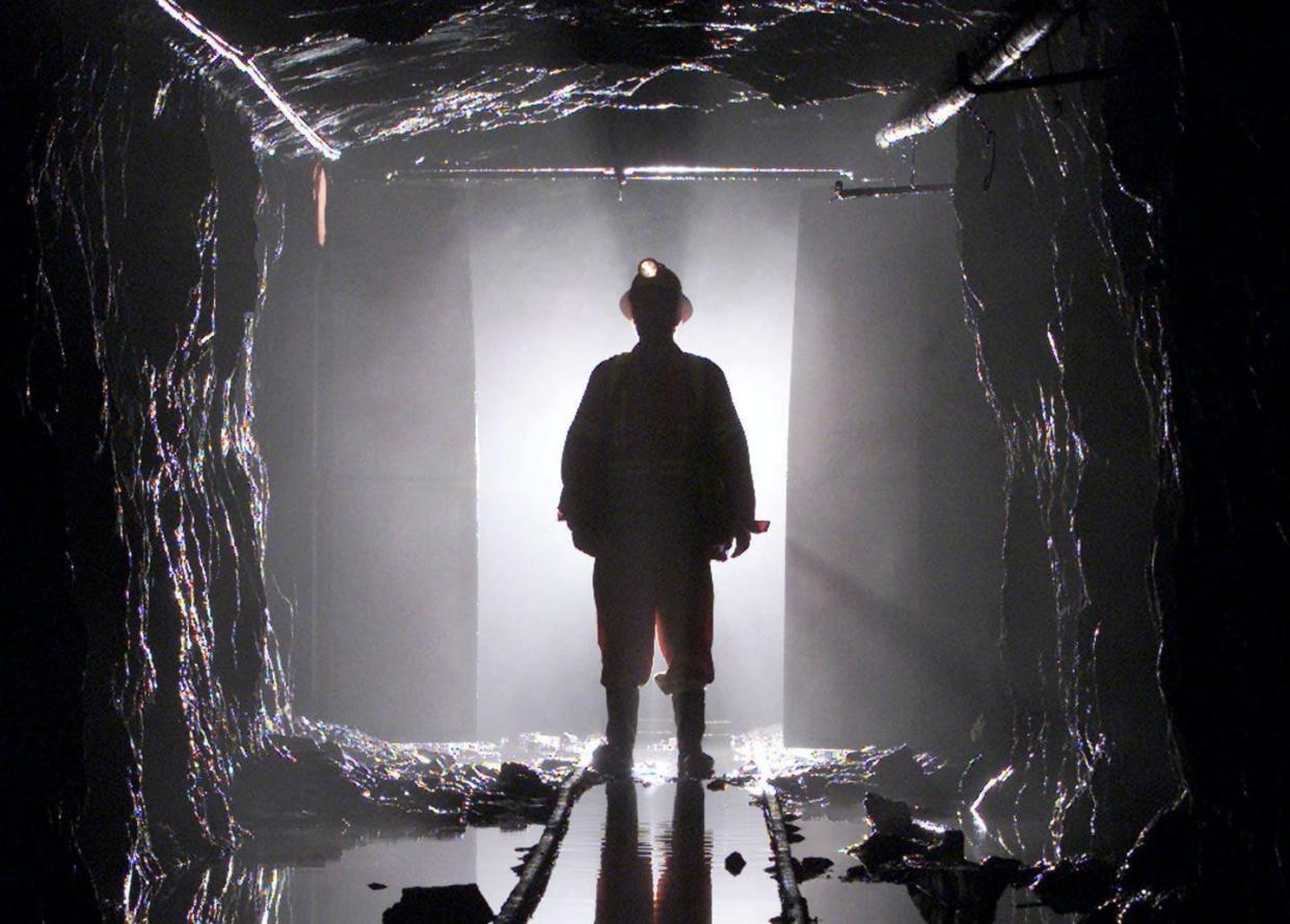 <span class="caption">A miner is silhouetted as he passes through a doorway in a mine shaft 100 feet below the surface at the Giant Mine near Yellowknife, N.W.T. in July, 2003.</span> <span class="attribution"><span class="source">THE CANADIAN PRESS/Adrian Wyld</span></span>