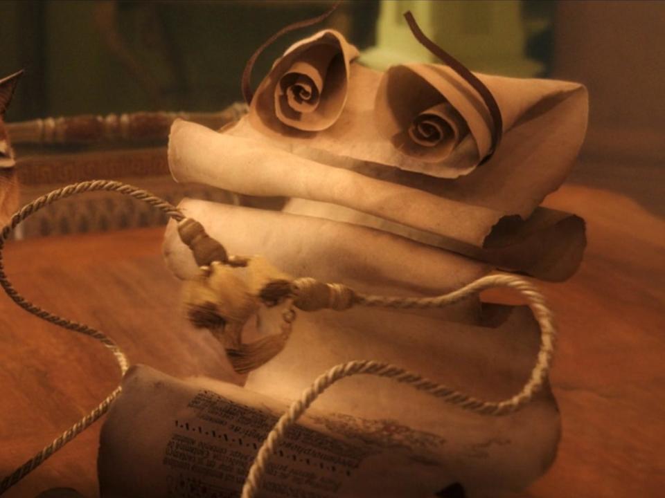 A cat and a scroll seen in "Disenchanted."