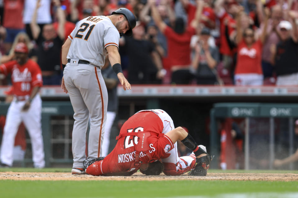 San Francisco Giants' Joey Bart, left, looks at Cincinnati Reds catcher Tyler Stephenson after Bart was tagged out at home plate for the final out of a baseball game in Cincinnati, Saturday, May 28, 2022. The Reds won 3-2. (AP Photo/Aaron Doster)