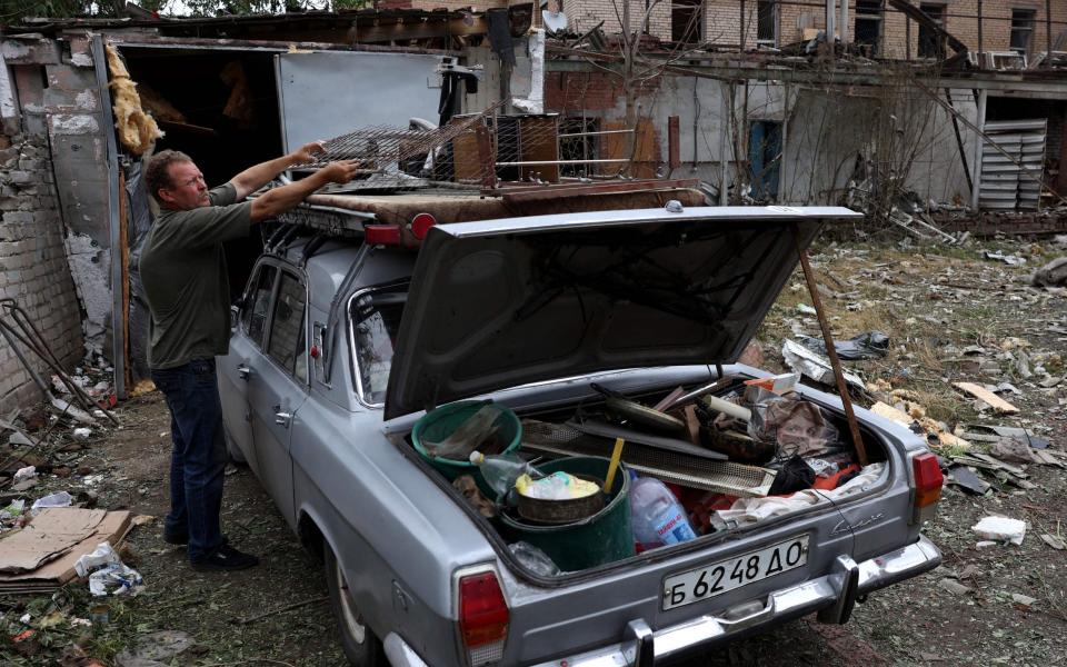 A local resident packs his belongings in a car after a night missile attack on the city of Kramatorsk, on July 9, 2023, amid the Russian invasion of Ukraine