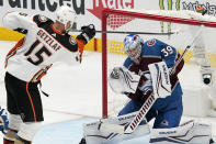 Anaheim Ducks center Sam Carrickm, right, deflects a shot by Anaheim Ducks center Ryan Getzlaf during the third period of an NHL hockey game Wednesday, Jan. 19, 2022, in Anaheim, Calif. (AP Photo/Mark J. Terrill)