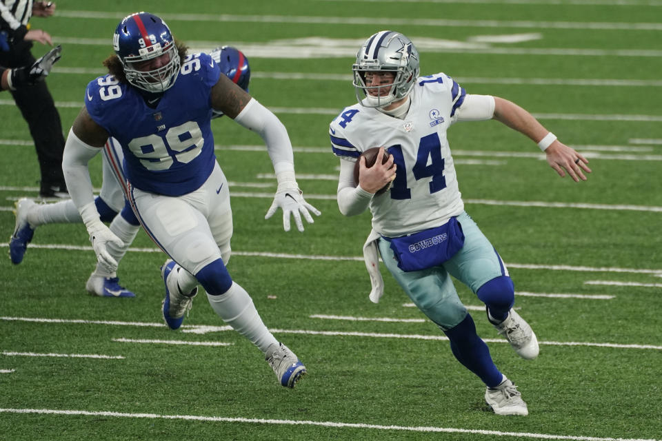 Dallas Cowboys quarterback Andy Dalton, right, tries to evade the New York Giants defense during the second half of an NFL football game, Sunday, Jan. 3, 2021, in East Rutherford, N.J. (AP Photo/Corey Sipkin)