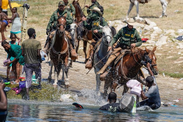 U.S. Border Patrol agents on horseback confront Haitian migrants trying to enter an encampment on the banks of the Rio Grande, in Del Rio, Texas, Sept. 19. (Photo: PAUL RATJE via Getty Images)