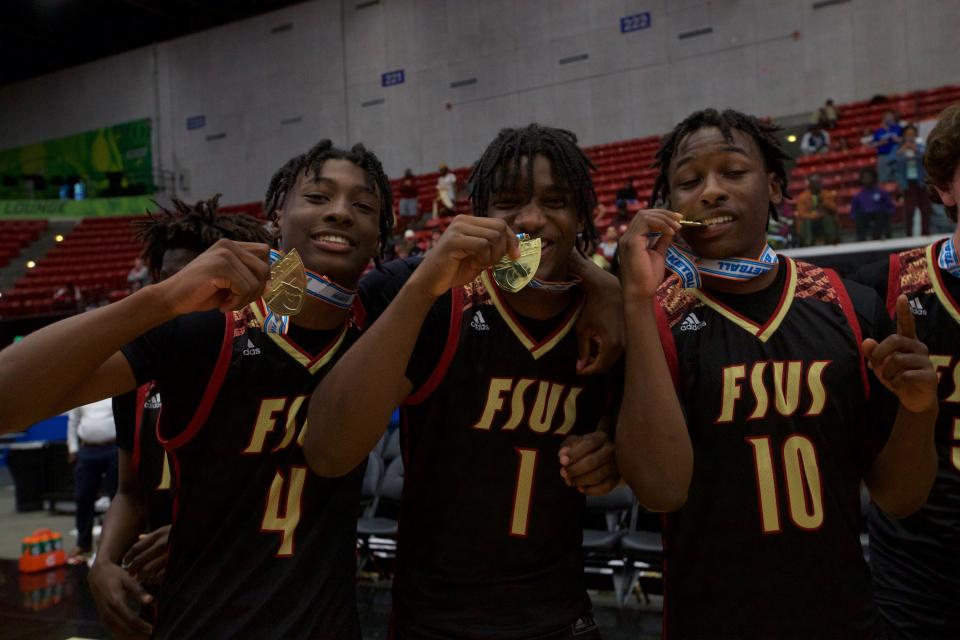 Florida High sophomore guard Ashton Hampton (4), senior guard Miles Evora (1) and senior forward Adrian Grant (10) celebrate with their medals following the Seminoles state championship win over Riviera Prep, 67-66, on March 4, 2022, at R.P. Funding Center.