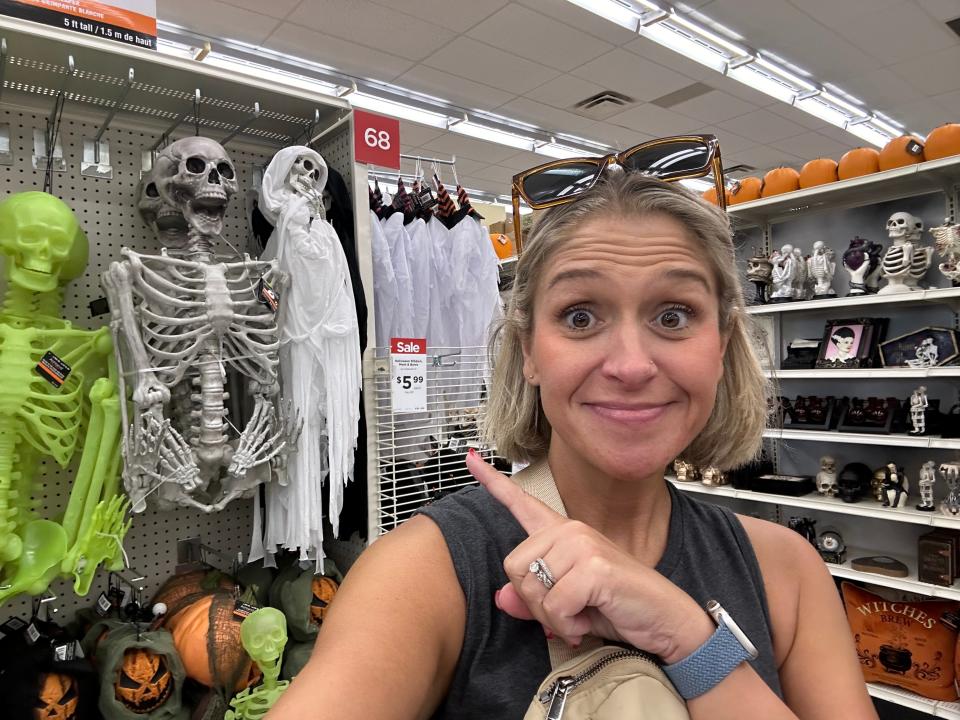 The author pointing to skeleton decor in a Michaels