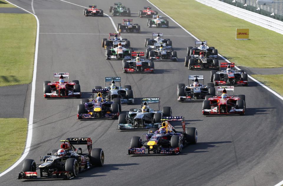 Lotus Formula One driver Romain Grosjean of France leads on the first corner during the Japanese F1 Grand Prix at the Suzuka circuit October 13, 2013. REUTERS/Issei Kato (JAPAN - Tags: SPORT MOTORSPORT F1)