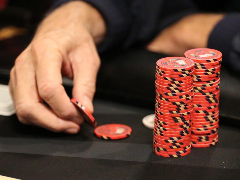 A poker player places a bet in this file photo.