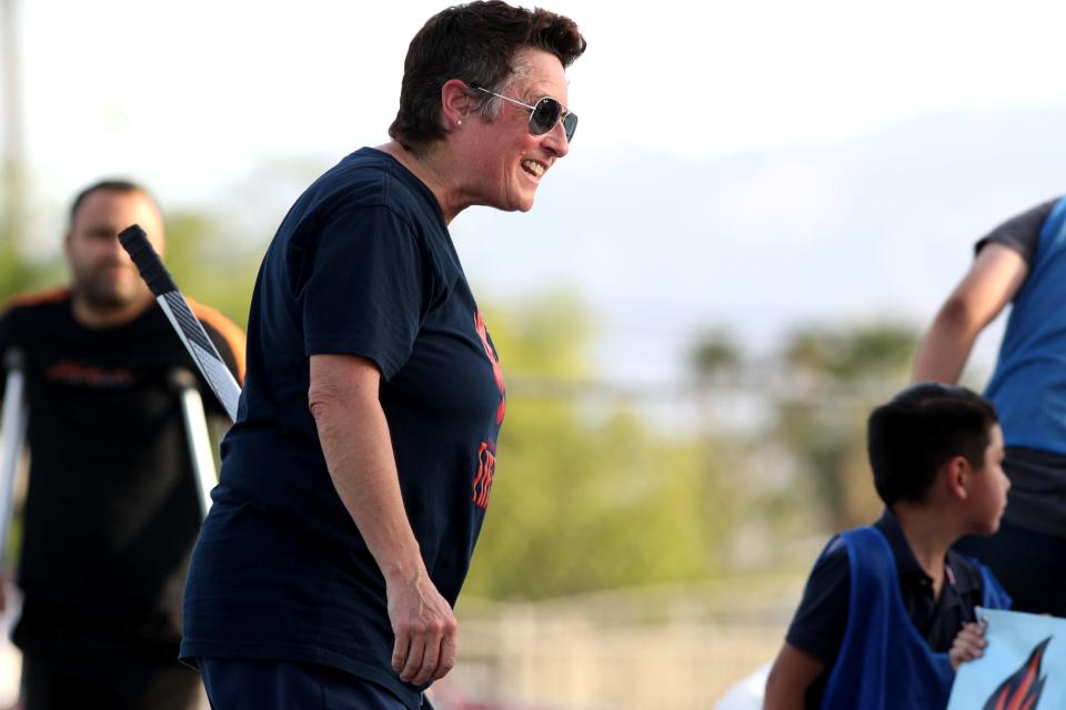 Former Olympic hockey coach Shannon Miller, left, interacts with youth during the Coachella Valley Firebirds and Acrisure Arena street hockey clinic at Mecca Community Park in Mecca, Calif., on Monday, May 23, 2022. 