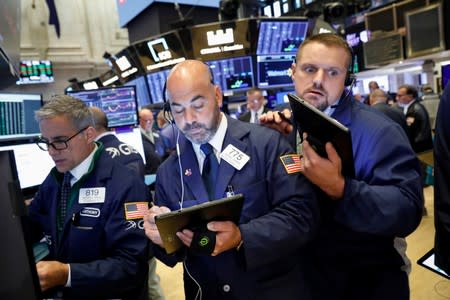 Traders work on the floor at the NYSE in New York