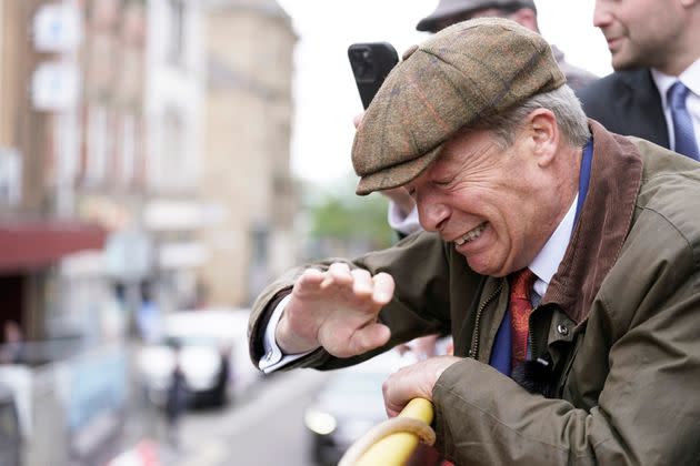 Reform U.K. leader Nigel Farage reacts after something is thrown towards him on a campaign bus in Barnsley, England.