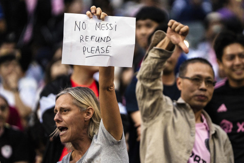 Fans react during the friendly soccer match between Hong Kong Team and US Inter Miami CF at the Hong Kong Stadium in Hong Kong, Sunday, Feb. 4, 2024. Lionel Messi's non-appearance was a disappointment for the fans who snapped up all 40,000 tickets at Hong Kong Stadium within an hour when they went on sale in December. (AP Photo/Louise Delmotte)