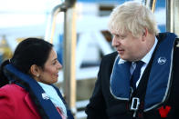 SOUTHAMPTON, ENGLAND - DECEMBER 2: Britain's Prime Minister Boris Johnson speaks with Home Secretary, Priti Patel aboard a security vessel at the Port of Southampton, Britain December 2, 2019. (Photo by Hannah McKay - WPA Pool/Getty Images)