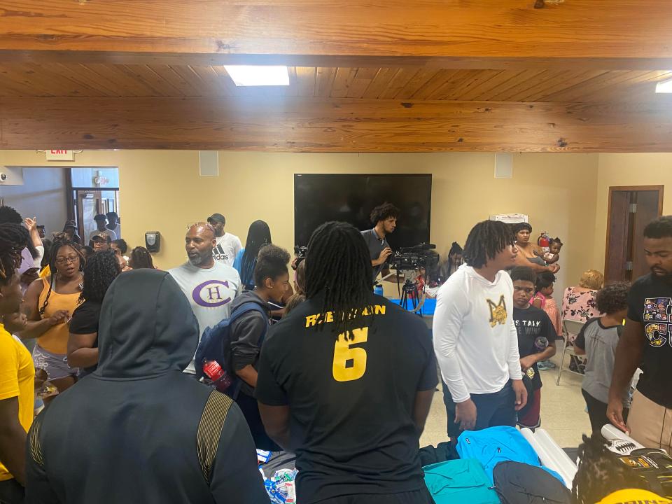 Missouri defensive lineman Darius Robinson, center, gives away backpacks at a back-to-school drive Saturday, Aug. 12, 2023, at Second Missionary Baptist Church in Columbia.