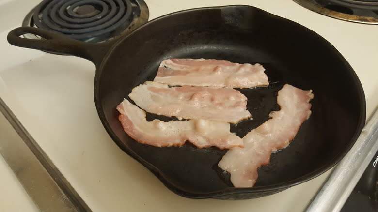 raw bacon in cast iron