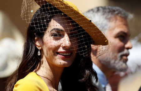 Amal Clooney and George Clooney arrive for the wedding ceremony of Prince Harry and Meghan Markle at St. George's Chapel in Windsor Castle in Windsor, Britain, May 19, 2018. Alastair Grant/Pool via REUTERS