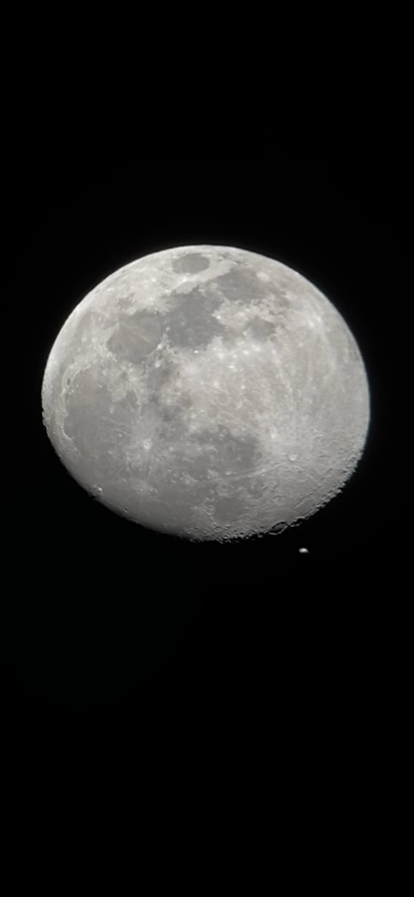 The International Space Station crosses past the moon on Sunday, April 2.